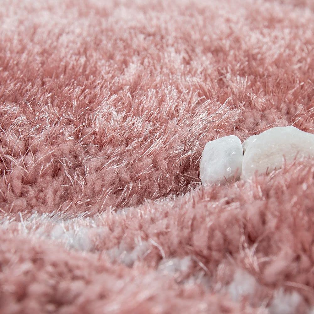 White decorative stones tucked into a RugNoor's fluffy blush pink shag carpet