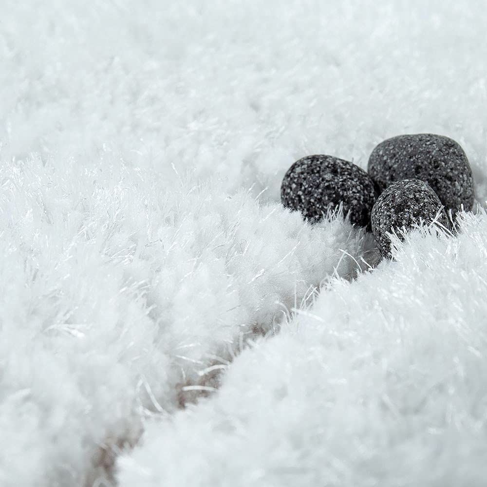 Black pebbles contrasting against RugNoor's fluffy snow-white carpet pile