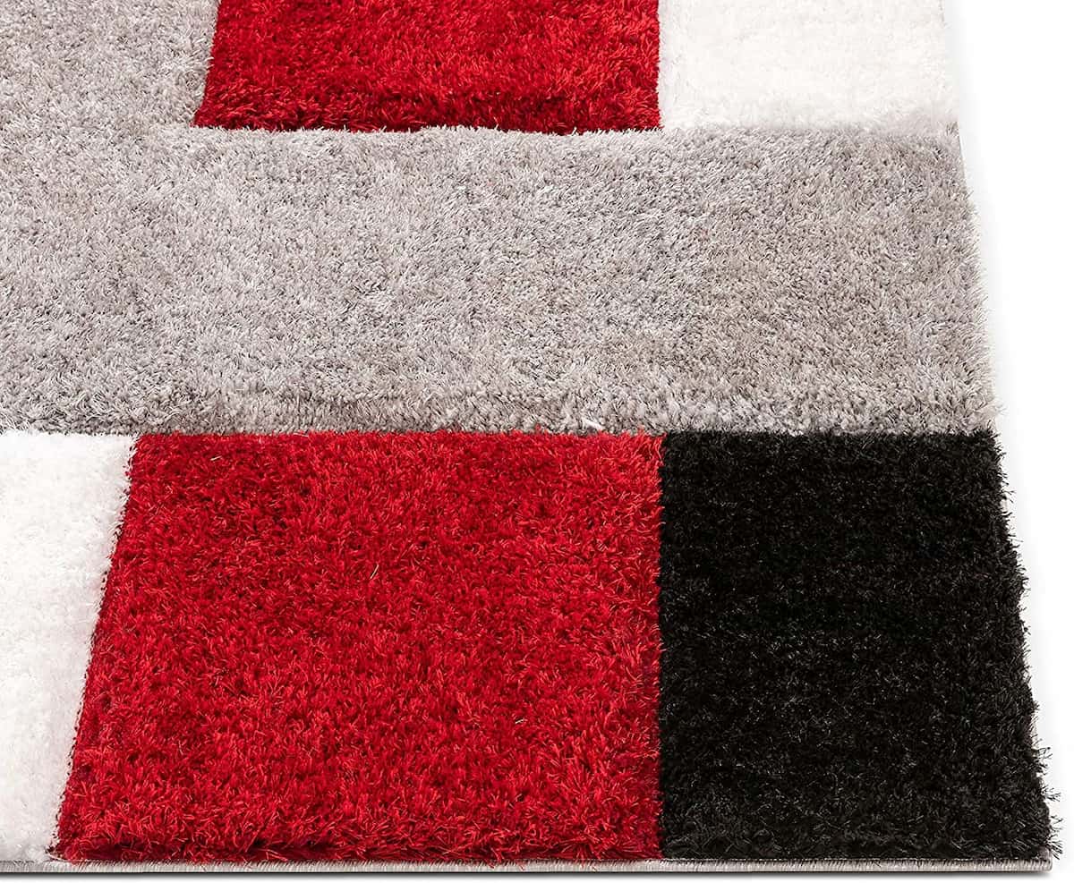 Close-up angle of RugNoor's block shag carpet in red, white and black