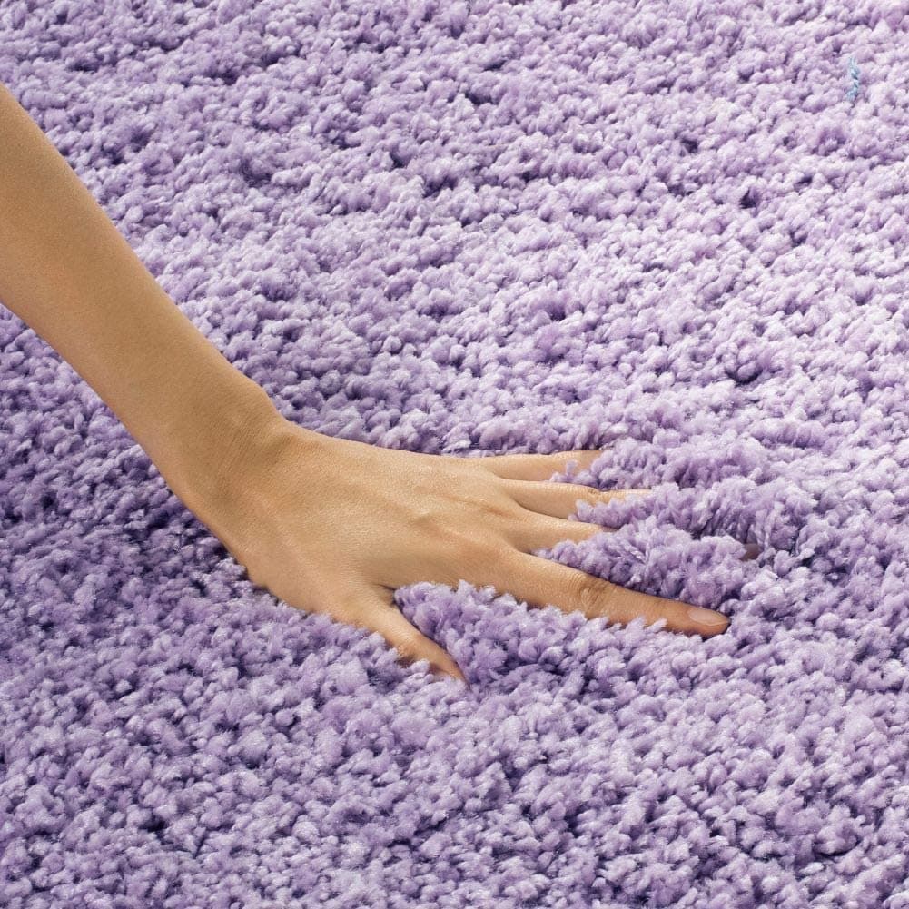 Hand pressing into fluffy lilac shag rug pile - RugNoor