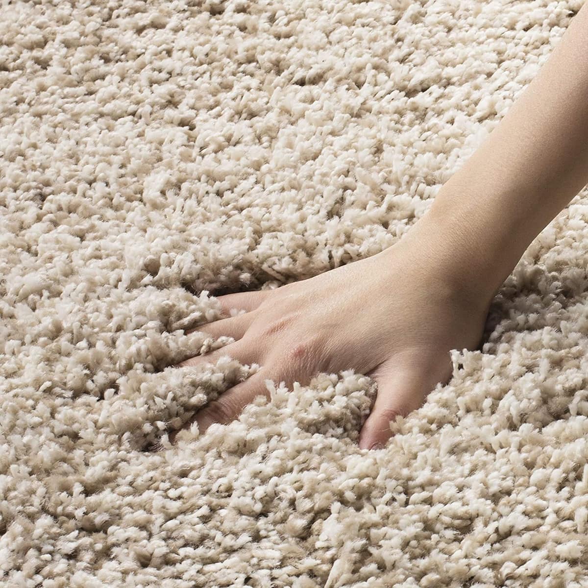 Beige shag carpet hand press, showing ultra soft fluffy pile texture - RugNoor