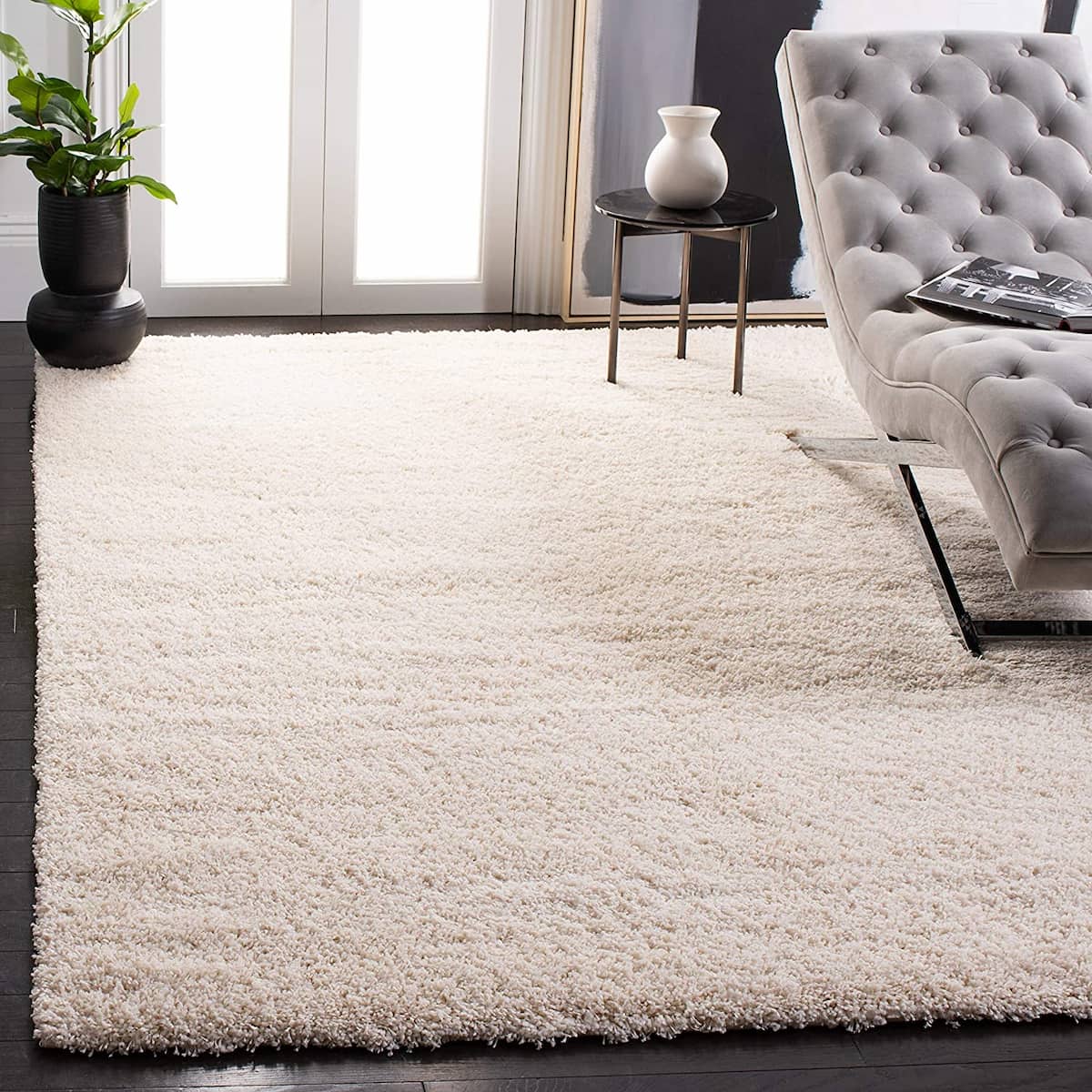 Ivory shag rug in living room with grey chaise and plant - RugNoor