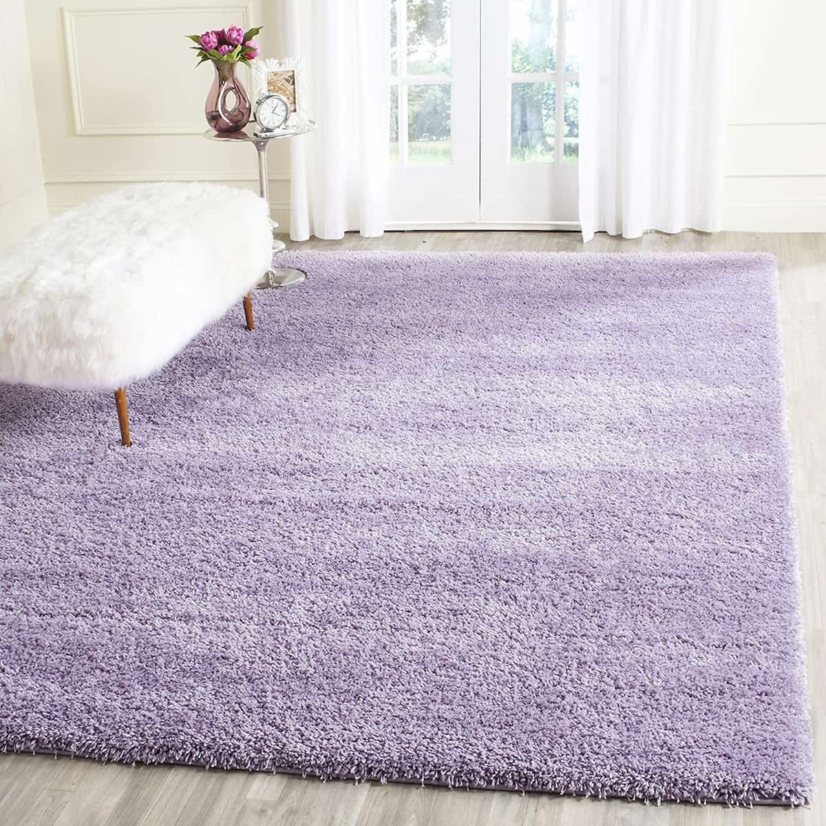 Lilac shag rug styled with white chair and floral decor - RugNoor