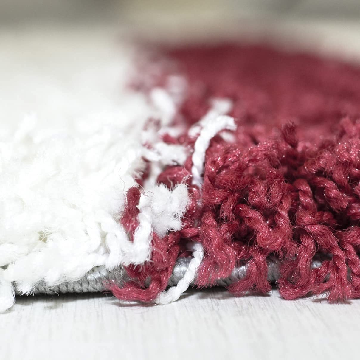 Macro shot of RugNoor's yarn fibers where deep red meets white pile