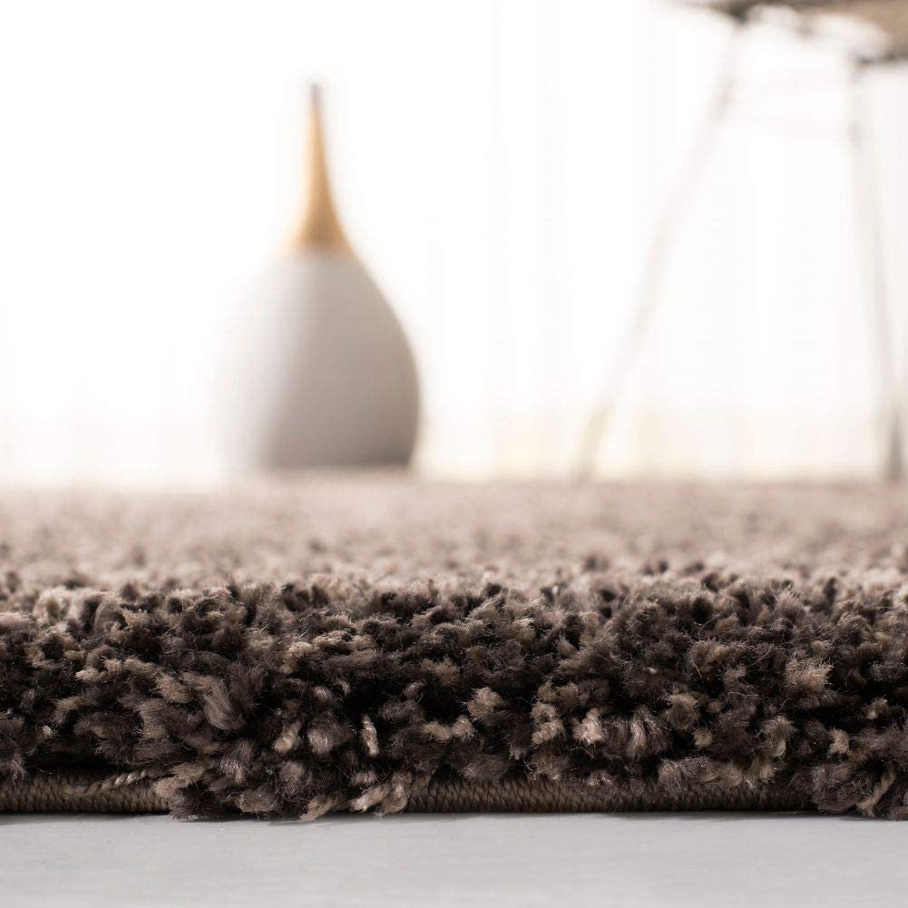 Mushroom brown shag rug edge close-up with ceramic vase decor - RugNoor