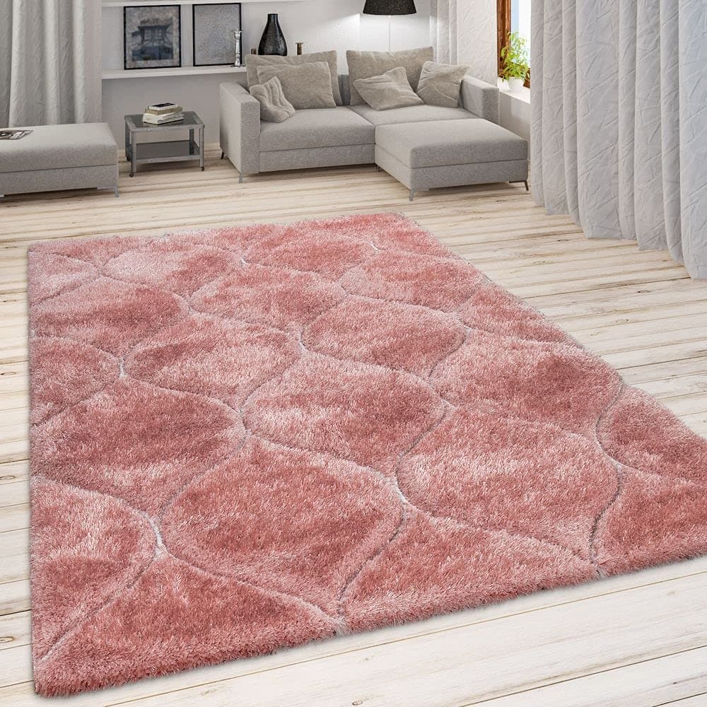 A RugNoor's pink microfiber shaggy rug with Ogee trellis pattern placed on a wooden floor in a living room setting.