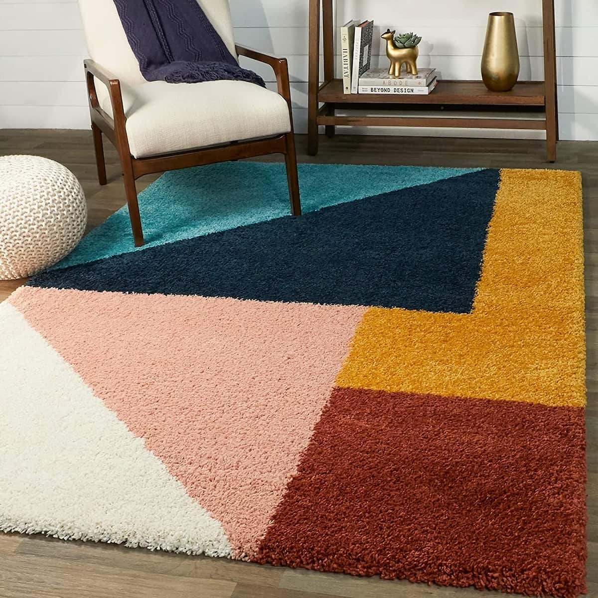 RugNoor's shaggy rug with geometric pattern in multiple colors placed on the floor under a chair and next to a decorative bowl.