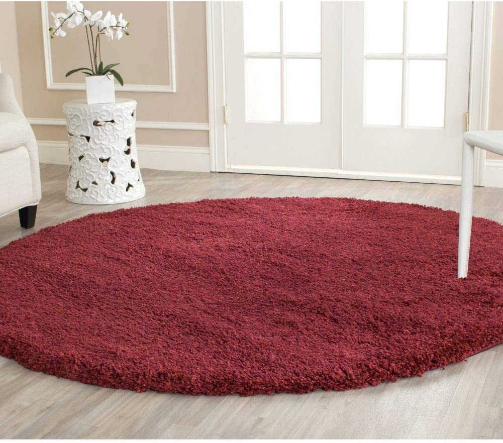 Round maroon shag rug in room with orchid decor - RugNoor