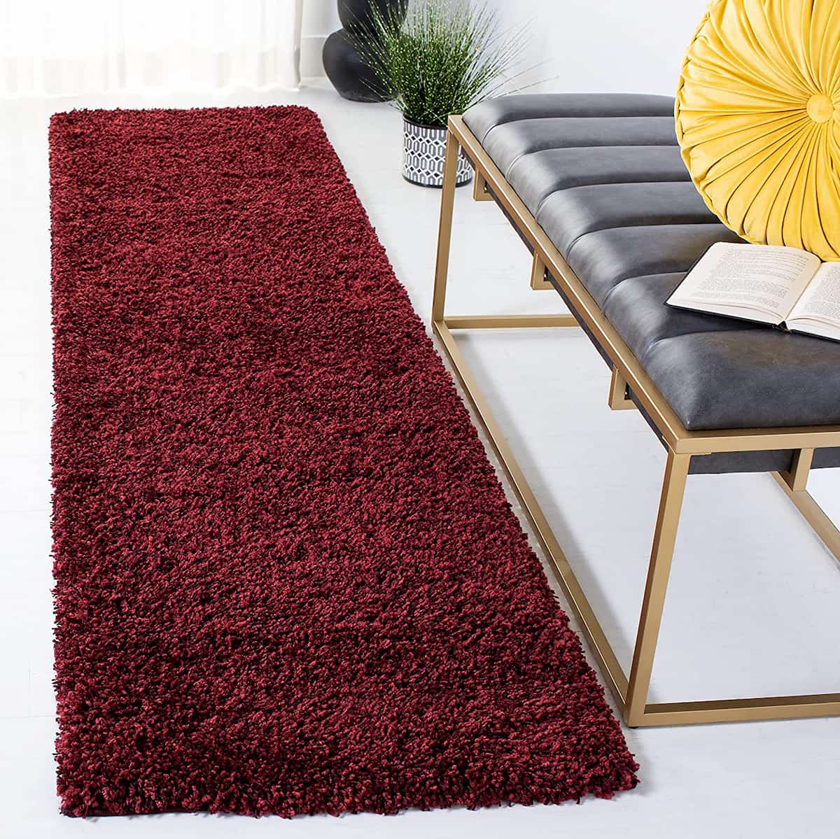 Maroon shag runner rug near bench with yellow cushion - RugNoor