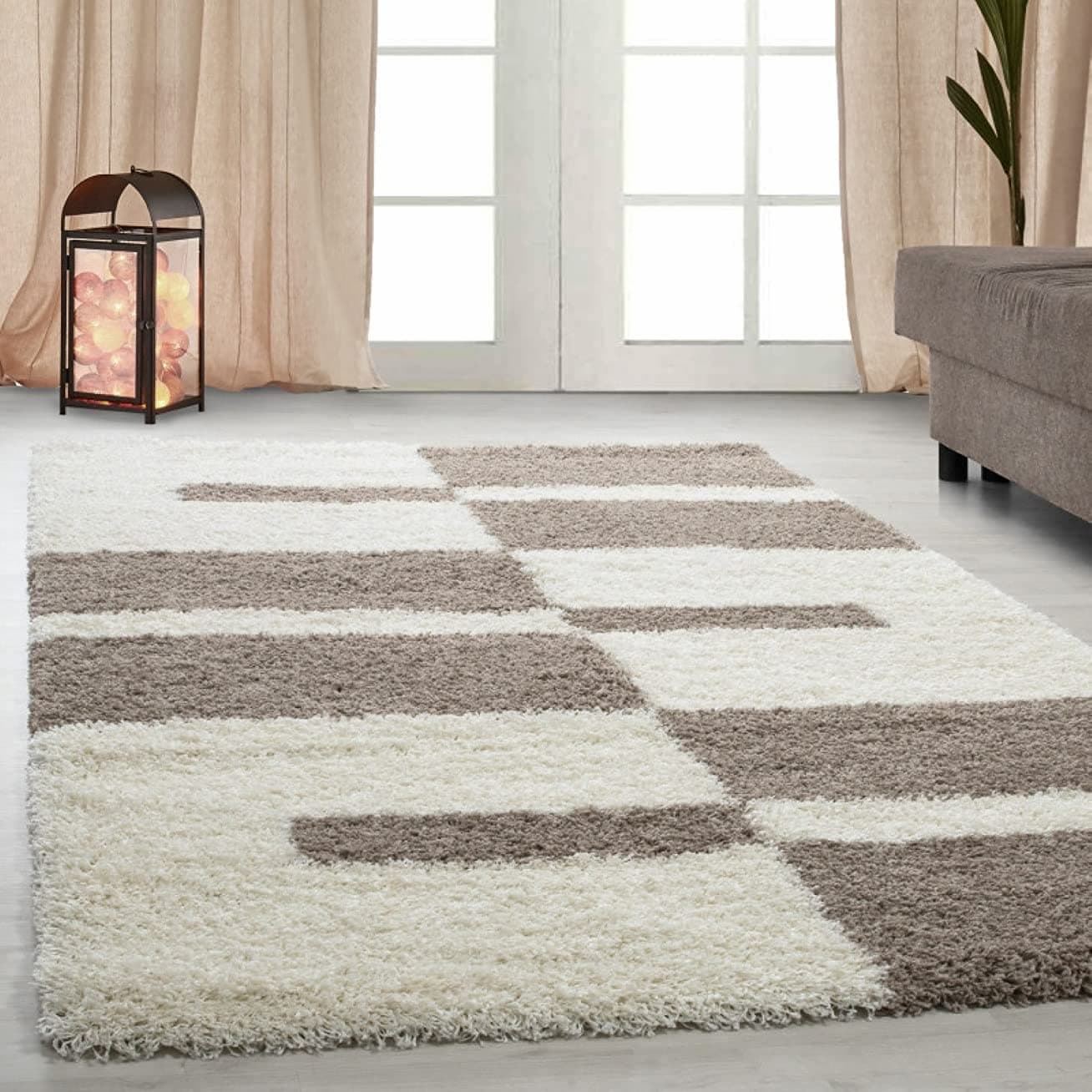RugNoor's white and brown microfiber shaggy rug with a block pattern, placed on a floor in a living room setting.