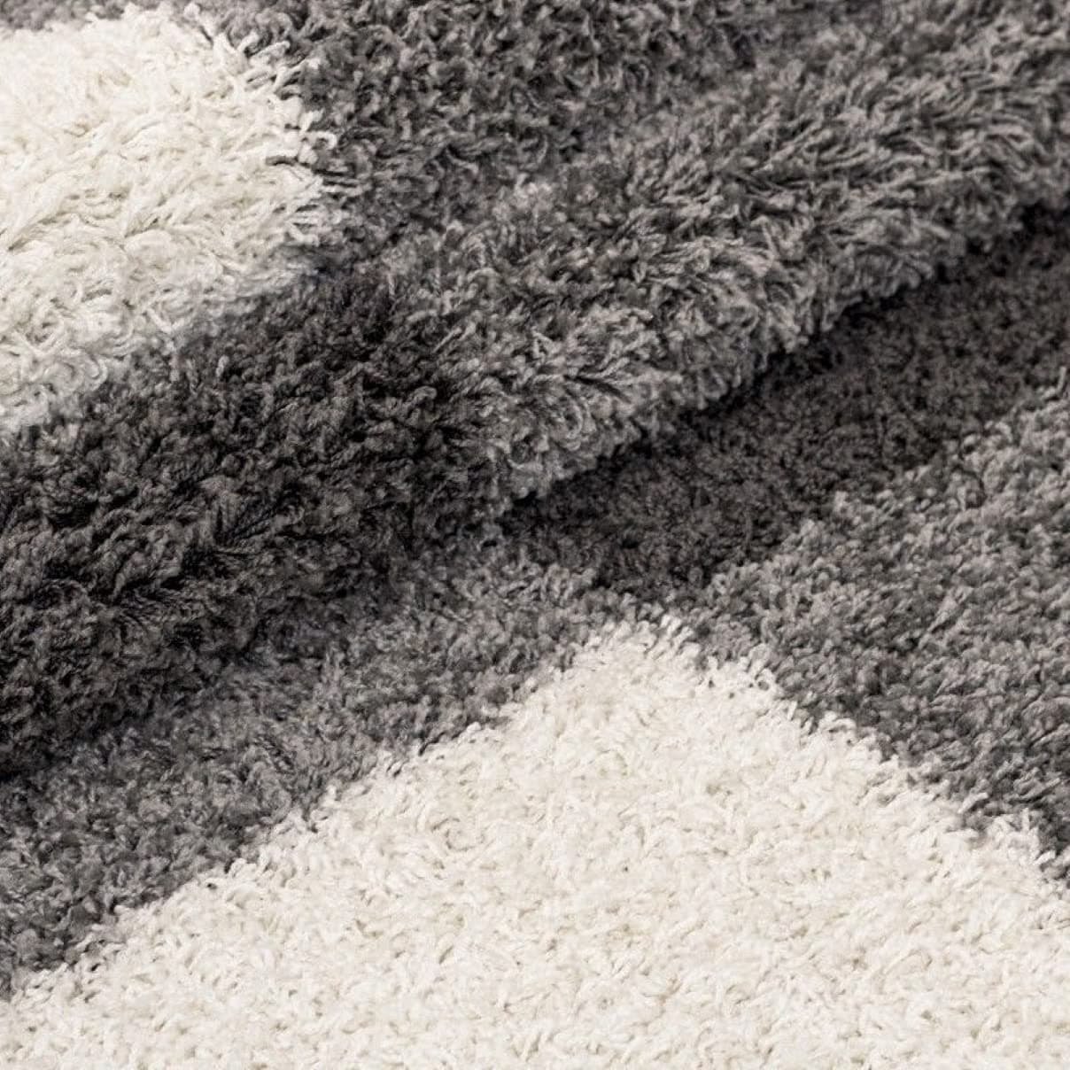 Close-up texture of RugNoor's contrasting dark and light carpet zones