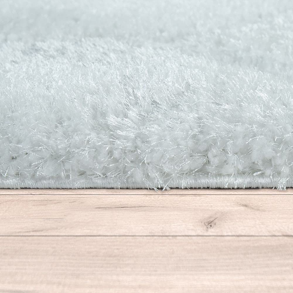 RugNoor's soft white carpet fibers shown up close along a wooden floor line